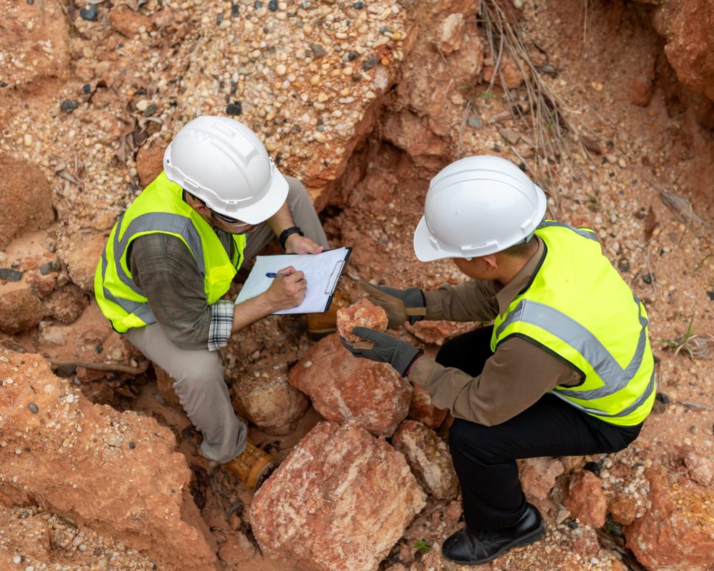 Geologists are analyzing the condition of mountain soil to find minerals